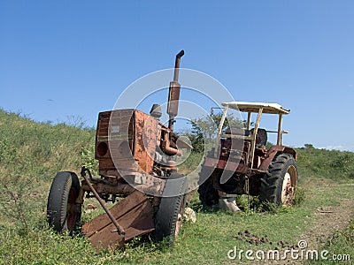 Broken rusty tractor on farm Stock Photo