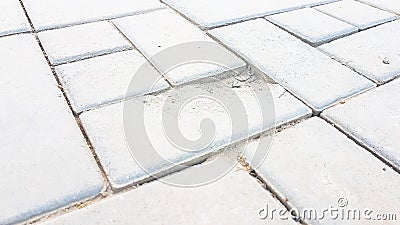 Broken square brick concrete walkway with dirty dust Stock Photo
