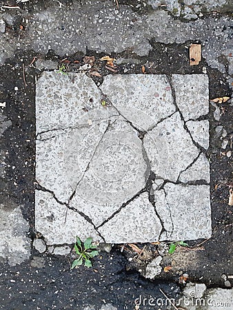 Broken square plate in the street in the yard Stock Photo