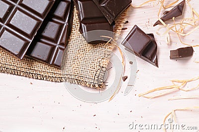 Broken tablet artisan chocolate on a wooden table top view Stock Photo