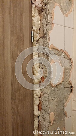 Broken tiles on a wall - under construction Stock Photo