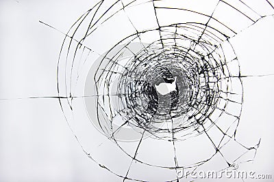 Broken transparent glass on the door window, a hole in the damaged glass due to vandalism Stock Photo