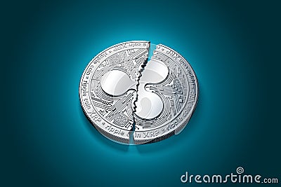 Broken into two pieces silver Ripple coin XRP Editorial Stock Photo