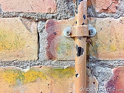 Broken water pipe on a brick wall Stock Photo