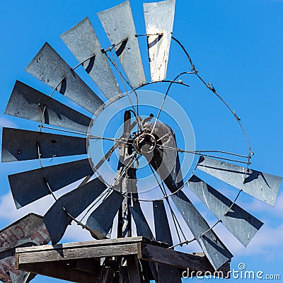 Broken windmill against a blue sky Stock Photo