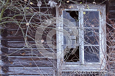 Broken window in an abandoned wooden house. The concept Stock Photo