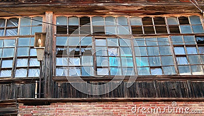 Broken windows of an abandoned house Stock Photo