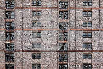 Broken windows on abandoned redbrick building Stock Photo