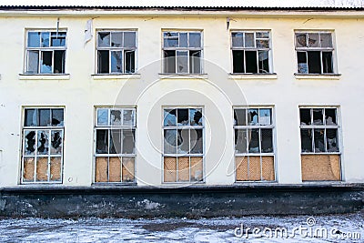 Broken windows in two stair abandoned building Stock Photo