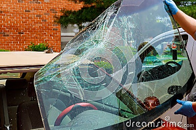 Broken windshield car special workers take of windshield of a car in auto service Stock Photo