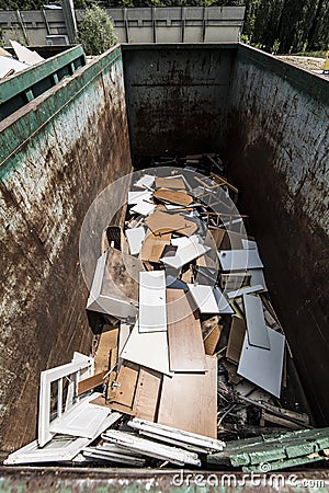 Broken wooden forniture recycling container Stock Photo