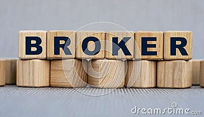 BROKER - word on wooden cubes on a beautiful gray background Stock Photo