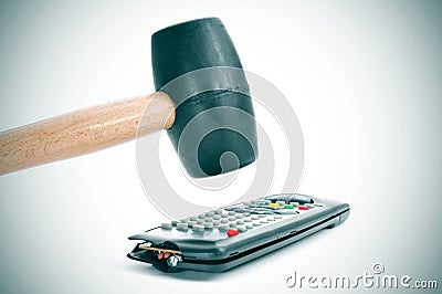Broking a remote control with a hammer Stock Photo