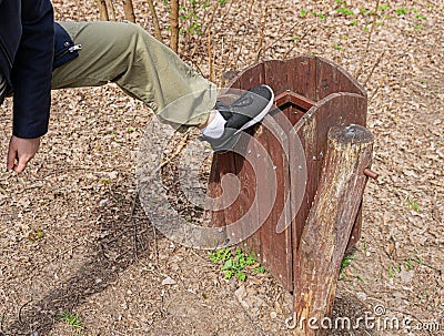 Broking Trash Bin by Vandal, Damaging Wooden Trash Can Stock Photo