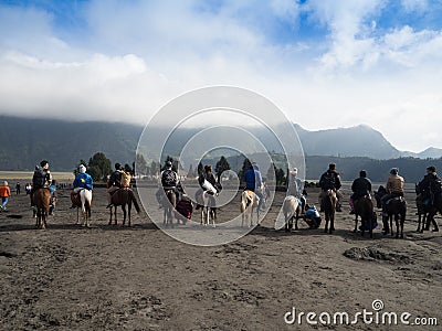 BROMO, INDONESIA - JULY 12, 2O17 : Tourists hiking up to the top of Mount Bromo, the active mount Bromo is one of the Editorial Stock Photo