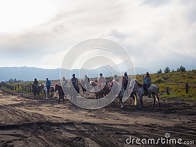 BROMO, INDONESIA - JULY 12, 2O17 : Tourists hiking up to the top of Mount Bromo, the active mount Bromo is one of the Editorial Stock Photo