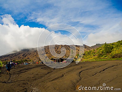 BROMO, INDONESIA - JULY 12, 2O17 : Tourists hiking up to the top of Mount Bromo, the active mount Bromo is one of the Editorial Stock Photo
