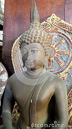 Bronz Buddha image and wheel of Dhama Stock Photo