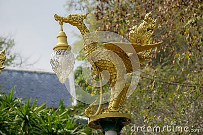 Bronze casting Thai literature swans carrying bell-shaped electricity lantern painted with gold colour Stock Photo