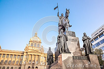 The bronze equestrian statue of St Wenceslas at the Wenceslas Square with historical Neorenaissance building of National Stock Photo