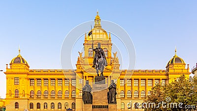 The bronze equestrian statue of St Wenceslas at the Wenceslas Square with historical Neorenaissance building of National Stock Photo