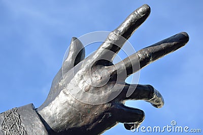 Bronze hand reaching outward Stock Photo