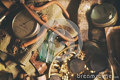 Bronze jewelry, old money, retro manometer, magnifier, glass bottle, silverware. Vintage Stock Photo