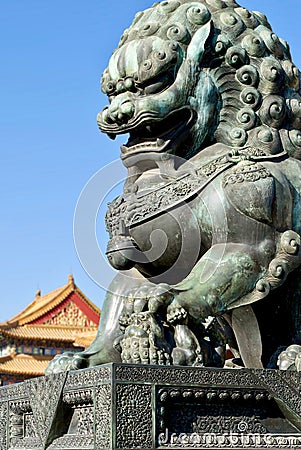 Bronze lions on the background of the buildings of the imperial palace. The Imperial Palace in Beijing Stock Photo