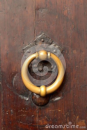 Bronze metal antique vintage door knock or knocker on an old wood door Stock Photo