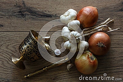 Bronze morter and group of garlics and onions Stock Photo