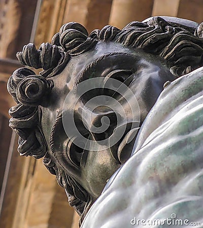 Bronze Perseus Statue Close Up Face Gazes Down at Camera Stock Photo