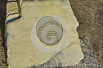 a bronze plaque with the inscription on the beach of cathedrals. Praia de Augas Santas, Ribadeo Editorial Stock Photo