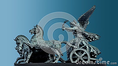 Bronze quadriga statue of goddess of Victory, Nike, at Austrian Parliament roof in Vienna, Austria, isolated at blue background, Stock Photo