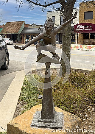 Bronze sculpture titled 'Paper Airplane' by Gary Lee Price in downtown Edmond, Oklahoma. Editorial Stock Photo