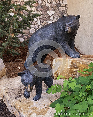 Bronze sculptures of a mother black bear and her cubs in Beaver Creek, Colorado. Editorial Stock Photo