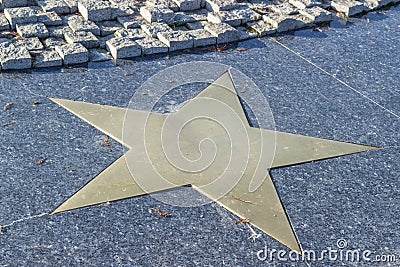 Bronze star in marble pavement Stock Photo