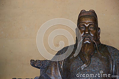 Bronze statue of Chinese man with hat and beard Stock Photo