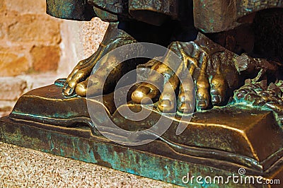 Bronze statue of feet over open book at Caceres Stock Photo
