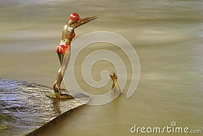 Bronze statue of girl swimmer jumping in Vardar Editorial Stock Photo