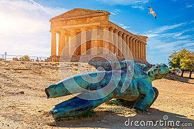 Bronze statue of Icarus in front of the Temple of Concordia at the Valley of the Temples. Temple of Concordia and the statue of Editorial Stock Photo