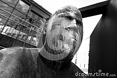 Bronze statue with the name, revolving door, in the pedestrian zone in Luebeck, Germany Editorial Stock Photo