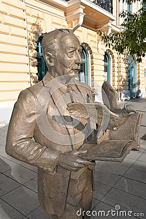 Bronze statue of the Serbian poet Veljko Petrovic holding a book from which a bird hatches Editorial Stock Photo