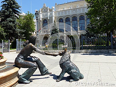 Bronze statues of a girl that plays with a dog to Budapest in Hungary. Editorial Stock Photo