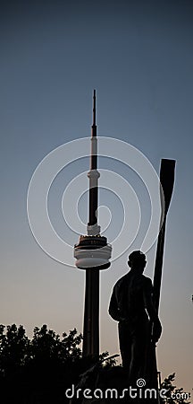 Bronze staue of Ewdard Ned Hanlan on Toronto island with the CN tower in the backround Editorial Stock Photo