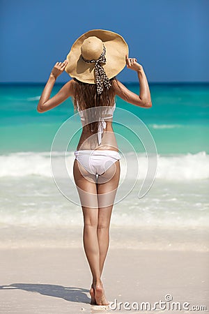 Bronze Tan Woman Sunbathing At Tropical Beach Stock Photo