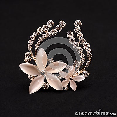Brooch flower with moonstone and diamonds isolated on black Stock Photo