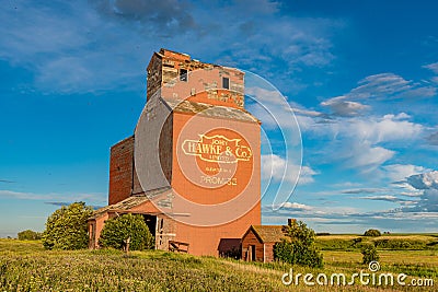 Brooking, SK- July 18, 2020: Sunset over the abandoned grain elevator in the ghost town of Brooking, SK Editorial Stock Photo