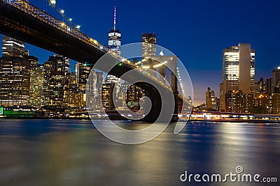 Brooklyn bridge at night with water reflection Stock Photo