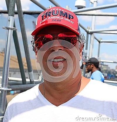 President Donal Trump supporter wears famous red hat with sign Trump Keep America Great 2020 Editorial Stock Photo
