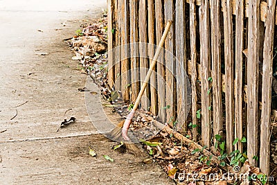 Broom against the wooden fence, home fence, background texture. Stock Photo